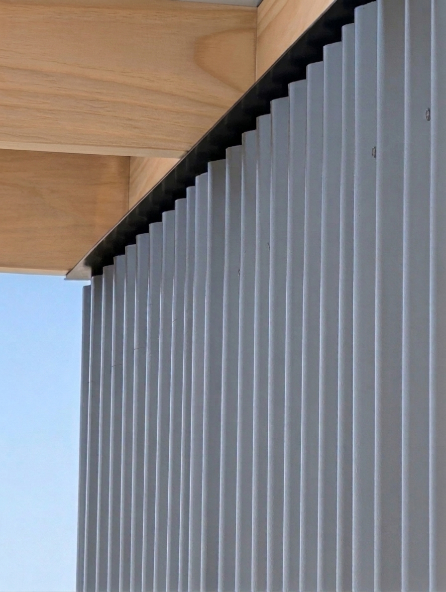 Corrugated cladding with plywood soffit — Sace Architects